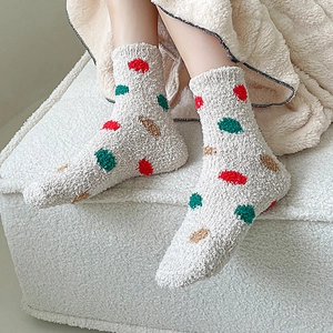 Cozy coral fleece mid-calf socks with colorful polka dots on beige soft plush material