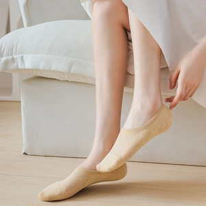 Detail of breathable low-cut invisible socks with vertical rib knit in beige cotton