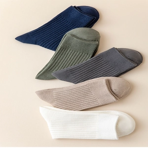 Detailed texture of vertical ribbed cotton crew socks in five assorted business colors
