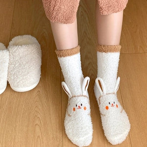 Detail of white fluffy coral fleece socks with 3D animal ears and cute rabbit embroidery