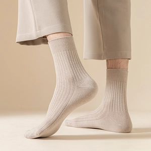 Close-up of beige ribbed mid-calf socks showing breathable cotton blend texture
