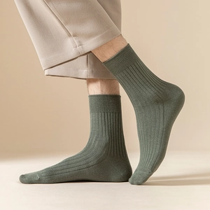 Macro detail of moss green ribbed cotton crew socks showing soft texture and elastic fit