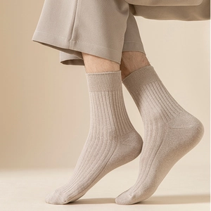 Detail of oatmeal ribbed crew socks featuring breathable cotton texture and elastic cuff