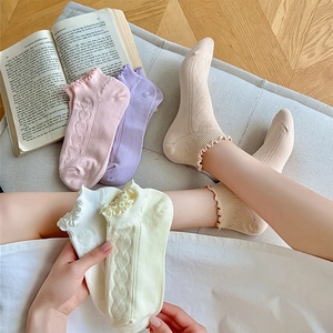 Detail of ruffle cuff ankle socks with 3D heart jacquard pattern in soft pastel colors