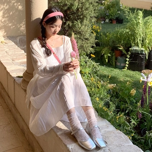 Detailed view of white floral lolita lace socks paired with silver Mary Jane shoes