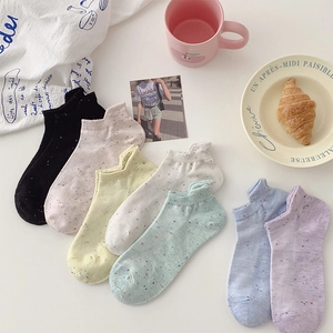 Close-up of low-cut cotton socks set in assorted pastel flecked marle colors with props