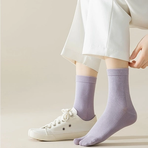 Purple tabi socks with ribbed texture styled with white sneakers for a modern look
