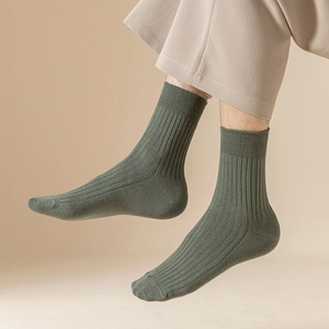 Close-up of olive green ribbed crew socks for men showing elastic texture and fit
