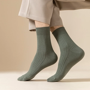 Detail of olive green ribbed mid-calf crew socks for men in a breathable cotton blend