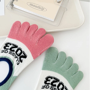 Detail of pink and green cotton five-finger socks with Class of 2023 knit text