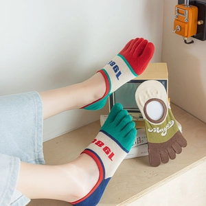 Detail of vintage five-finger cotton socks with colorful patchwork and 1986 letter print