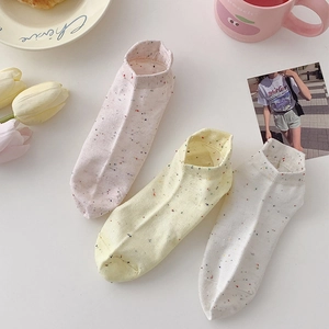 Detailed view of three pairs of pastel cotton no-show socks with colorful polka dots
