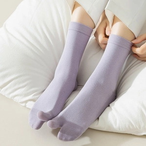 Close-up of light purple two-toe tabi socks featuring a ribbed knit texture and elastic fit