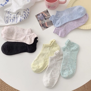 Close-up of multicolored speckled cotton boat socks with breathable knit texture