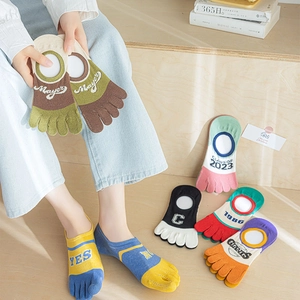 Detail of colorful five-finger socks showing vibrant patchwork design and knit texture