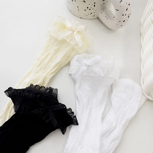 Detail of Lolita knee-high socks featuring lace trim, satin bows, and hollow mesh texture