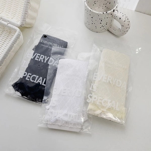 Detailed view of lace trim socks in black, white and beige with bow tie details
