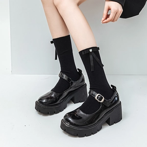 Détail de chaussures Mary Jane en cuir verni noir avec chaussettes à nœud Lolita