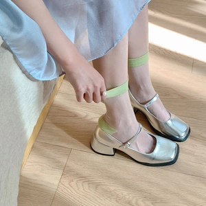 Silver metallic Mary Jane shoes with square toe and mid block heel on wooden floor