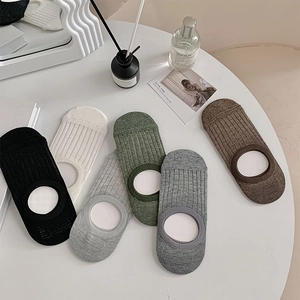 Detail view of cotton no-show socks in 6 colors featuring ribbed texture on a white table