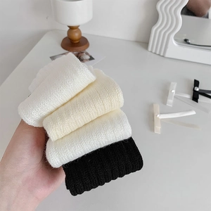 Detailed texture of ribbed knit socks in white, beige, and black cotton blend set