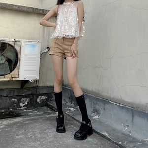 Japanese Lolita style knee-high socks paired with black platform Mary Jane shoes