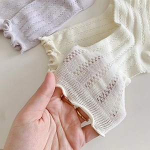 Detail of breathable mesh knit socks with ruffle trim showing elastic texture