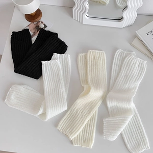 Detail of ballet style leg warmers with ribbed texture and dainty ruffled edges