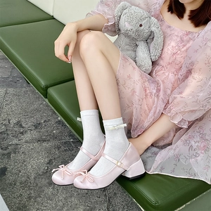 Pink satin Mary Jane shoes with bow detail and white socks for a sweet Lolita style