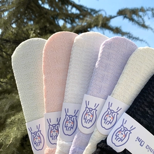 Detail of floral lace mesh socks in pastel colors with high breathability and texture