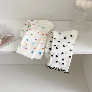 Close-up of breathable mesh polka dot socks with wavy edges and colorful knit patterns