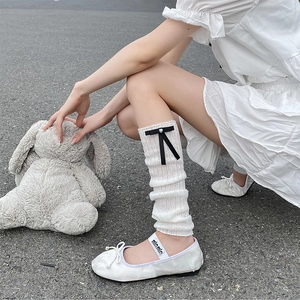 Balletcore white knit leg warmers with black satin bows and heart charms decoration