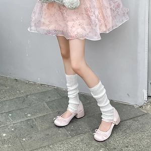Detail of pink satin Mary Jane shoes with bow decoration and chunky square heels
