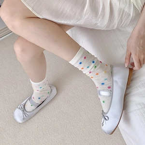 Polka dot mesh crew socks paired with silver satin ballet flats and Mary Jane straps