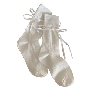 White ballet style knee high socks with ribbon bows and vertical ribbed knit texture