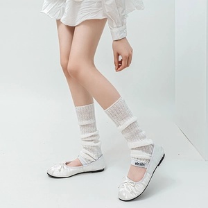 Detailed texture of white Lolita knit leg warmers paired with ballet flats