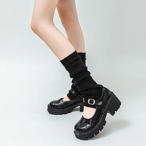Detail of black patent leather Mary Jane shoes with matching knitted leg warmers for JK style