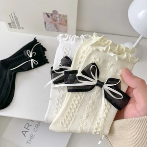 Detailed view of Lolita style calf socks with lace trim and double layered ribbon bows