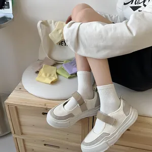 Detailed view of pastel cotton knit crew socks paired with vintage canvas mary jane shoes