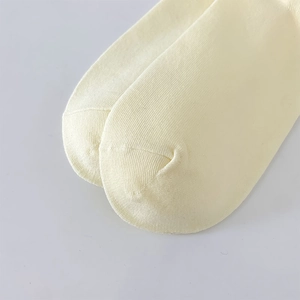 Close-up of beige knit socks showing premium combed cotton texture and smooth toe seam
