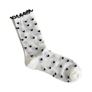 White crew socks for women featuring black heart patterns and elegant ruffle cuffs