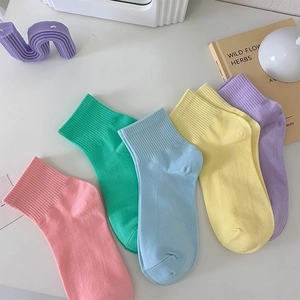 Set of five macaque color cotton mid-calf socks with elastic ribbed cuffs on a white desk