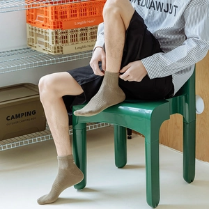 Close-up of khaki ribbed crew socks with detailed knit texture for a casual outdoor look