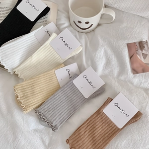 Detail of ribbed cotton mid-calf socks with ruffle trim in various pastel colors