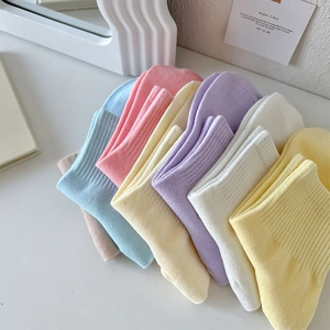 Close-up of ribbed cuffs on colorful pastel cotton socks in a fan-shaped arrangement
