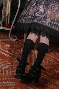 Detail of black lace trim calf socks paired with triple buckle Mary Jane Lolita shoes