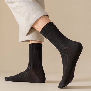 Close-up of men's black ribbed mid-calf socks with high elasticity and cotton texture