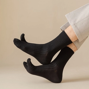 Macro detail of black cotton Tabi socks with ribbed texture and split-toe design