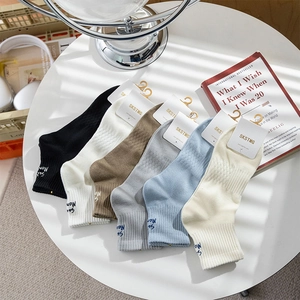 Close-up of six pairs of men's crew socks with diamond texture and heel embroidery
