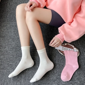 Detailed texture of white rib-knit crew socks with smooth cotton blend finish